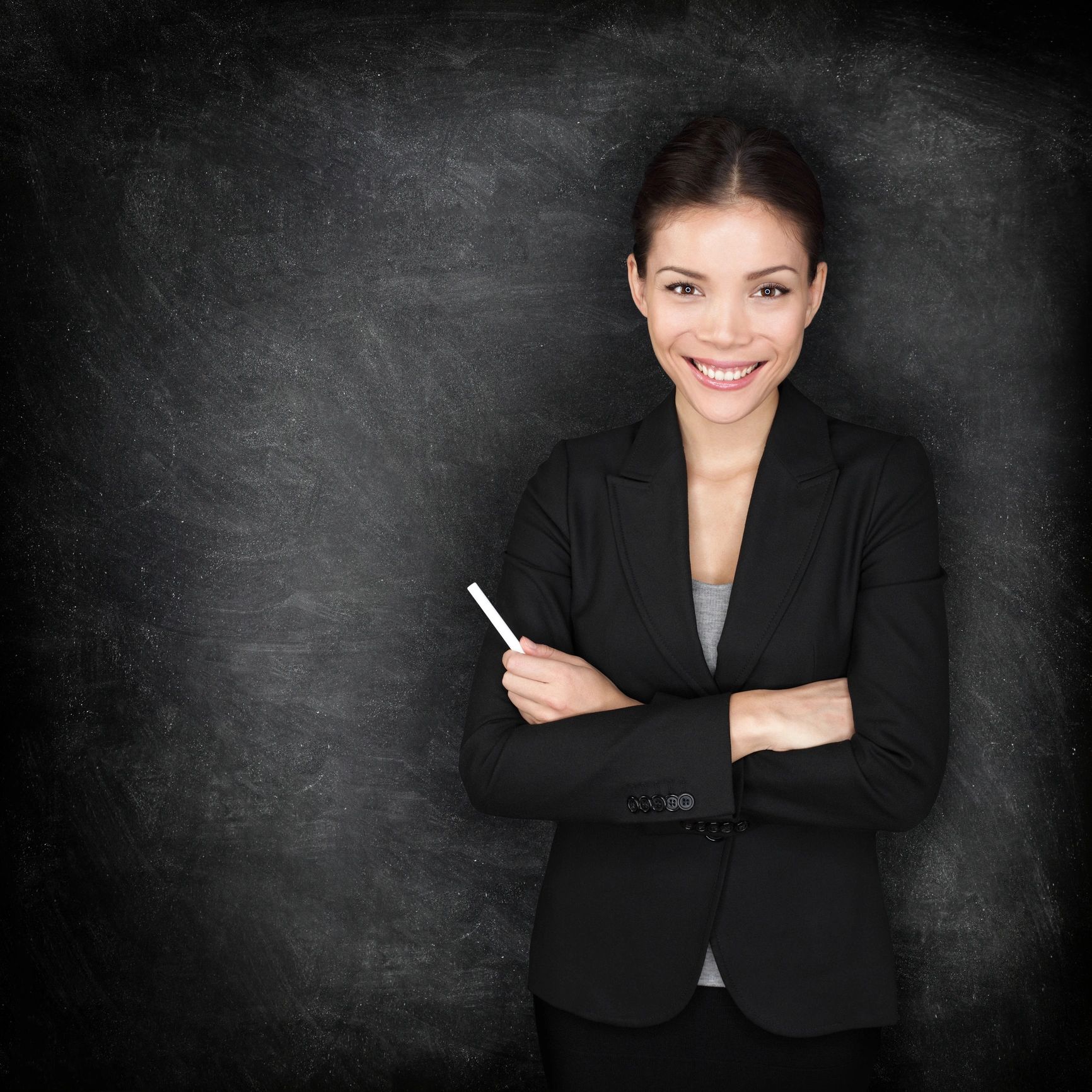Portrait of a language teacher in front of a classroom board